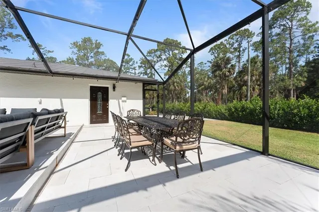 a outdoor space with the couches and dining table with the view of the balcony