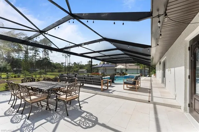 a view of a patio with a table and chairs