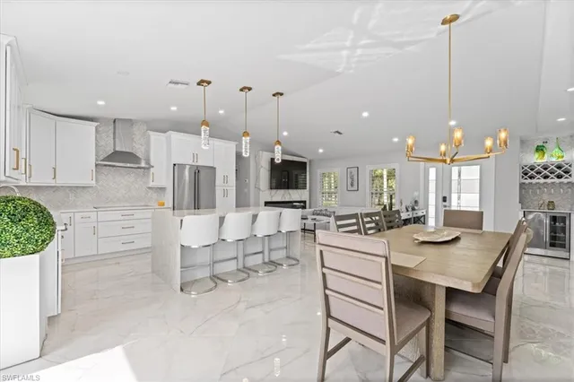 a large kitchen with a table and chairs