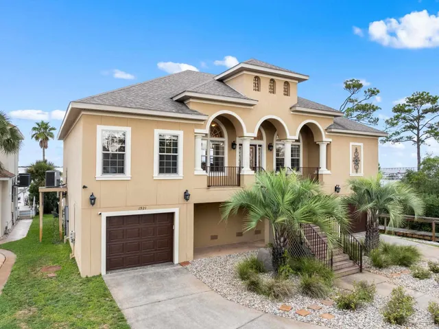 a front view of a house with a garden