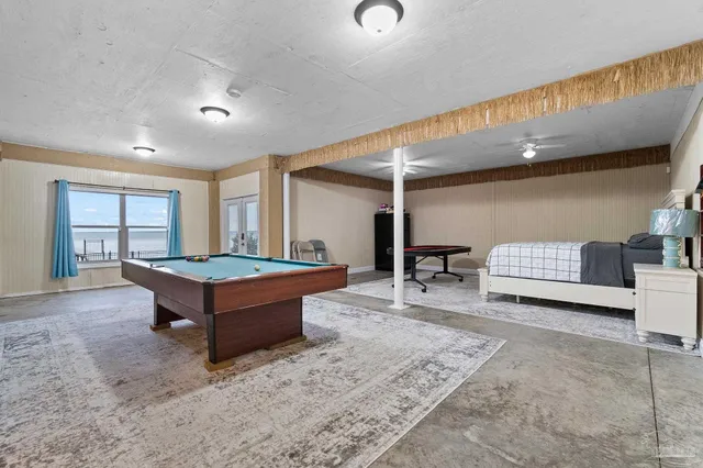 a living room with furniture a table and flat screen tv