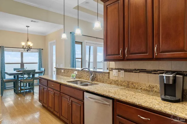 a kitchen with sink cabinets and wooden floor