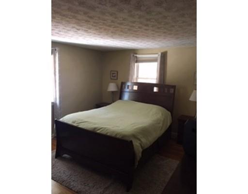 113 Concord Road Chelmsford, MA 01824 - Photo 8 of 14 a bed sitting in a bedroom next to a window
