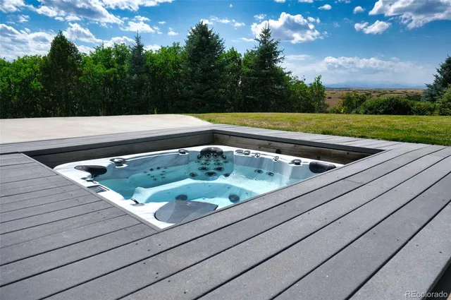 a bedroom with a bed and a large window with balcony view