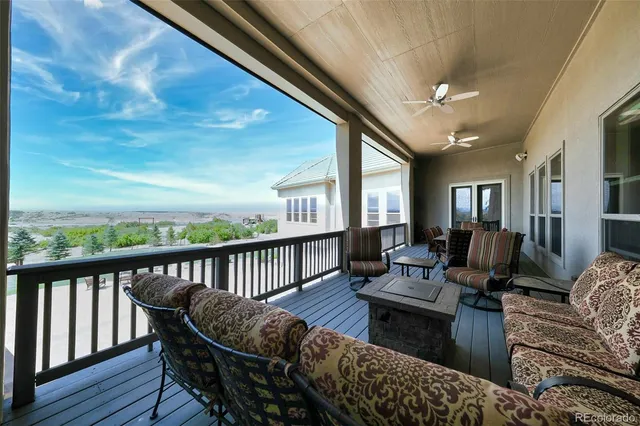 a living room with furniture fireplace and a large window