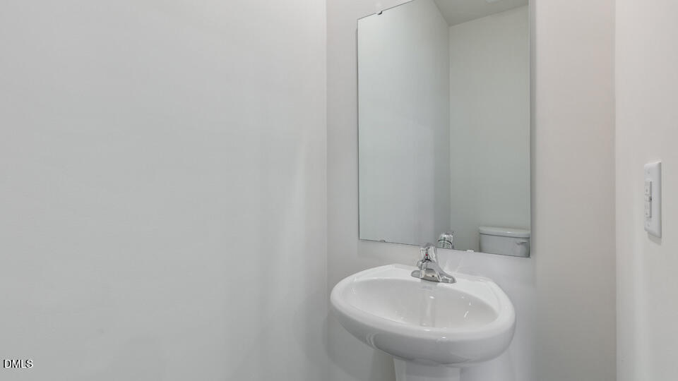 910 Sculptor Street Wendell, NC 27591 - Photo 13 of 44 a bathroom with a sink and a mirror
