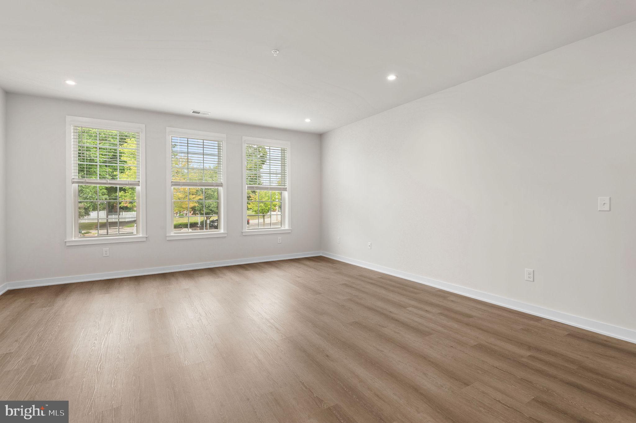 26 South York Road, Unit 402 Hatboro, PA 19040 - Photo 43 of 52 an empty room with wooden floor and windows