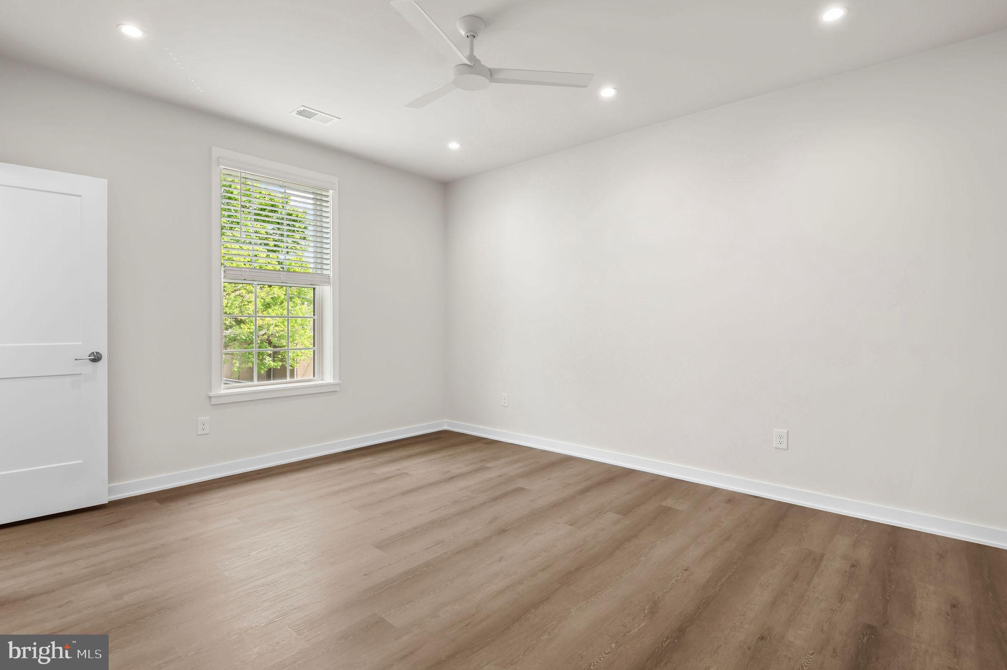 26 South York Road, Unit 402 Hatboro, PA 19040 - Photo 47 of 52 an empty room with wooden floor and windows