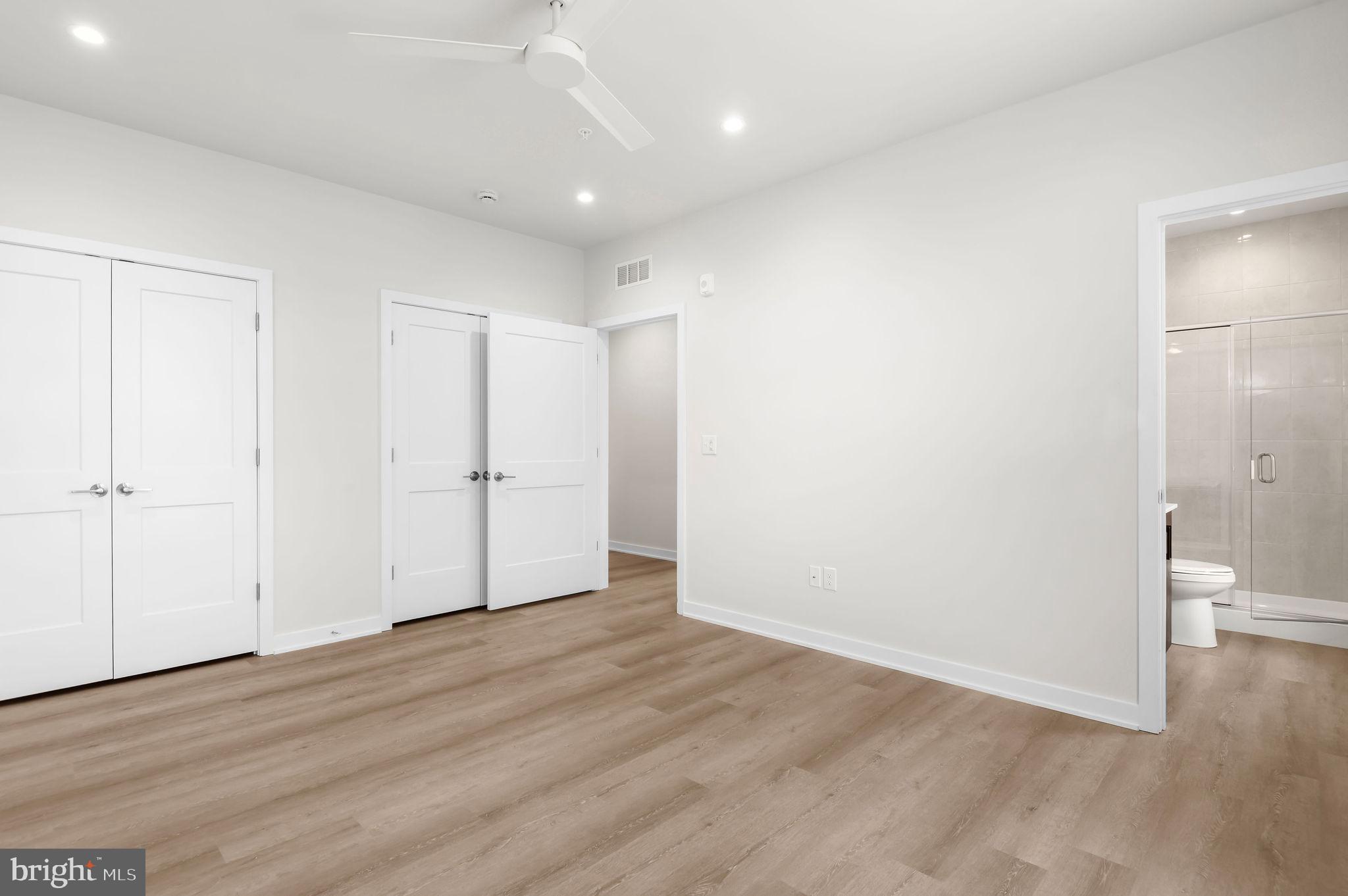 26 South York Road, Unit 402 Hatboro, PA 19040 - Photo 48 of 52 an empty room with wooden floor and bathroom