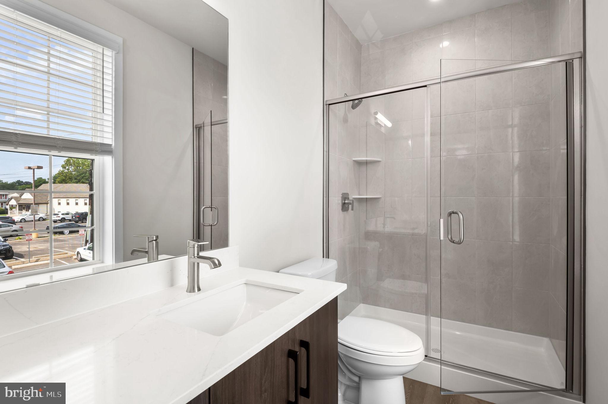 26 South York Road, Unit 402 Hatboro, PA 19040 - Photo 49 of 52 a bathroom with a sink toilet and shower