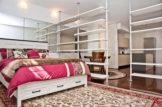a bedroom with a bed and the view of closet