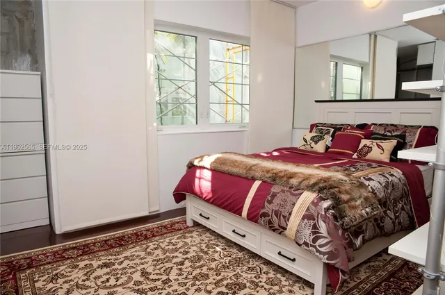 a bed sitting in a bedroom next to a window