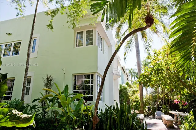 a palm tree sitting in front of a building