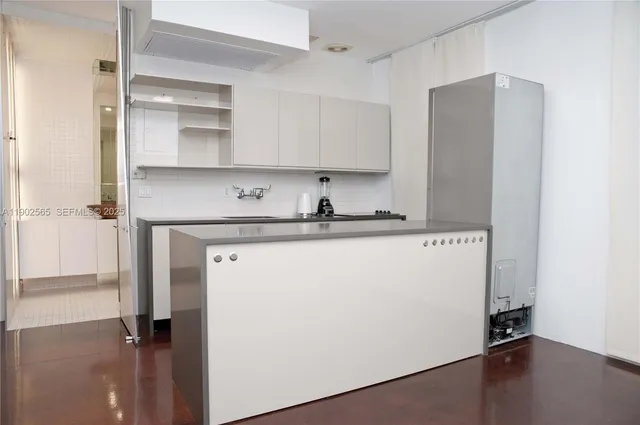 a kitchen with a refrigerator and a sink