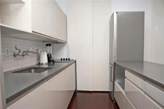 a kitchen with a sink and refrigerator