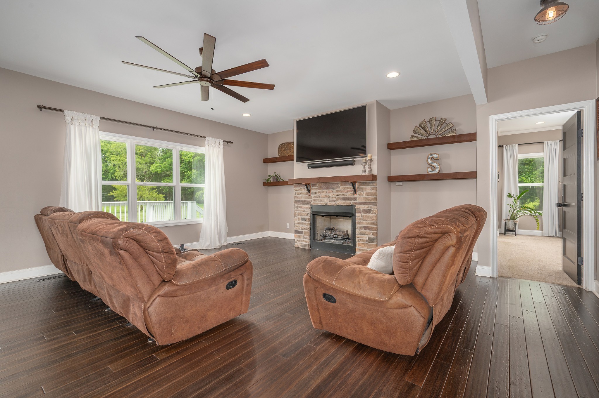 1675 Walnut Hill Road Lebanon, TN 37090 - Photo 11 of 54 a living room with furniture a fireplace and a flat screen tv