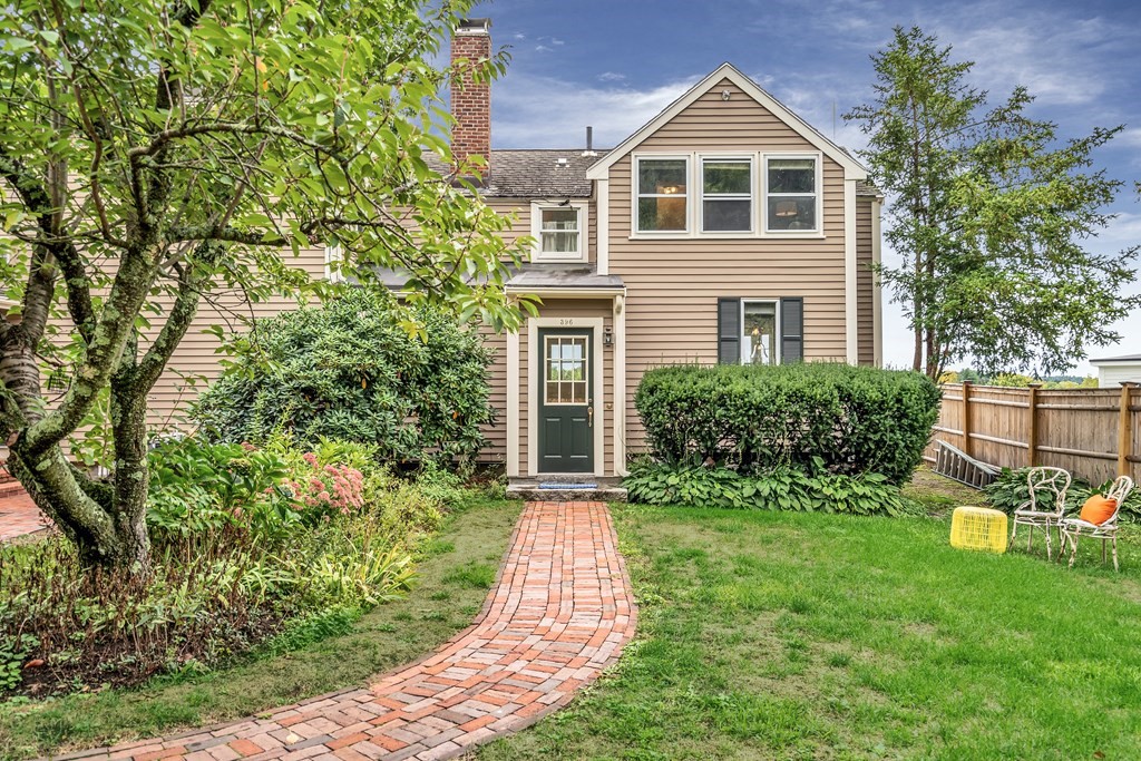 396 Plainfield Road, Unit 396 Concord, MA 01742 - Photo 1 of 24 a front view of a house with garden