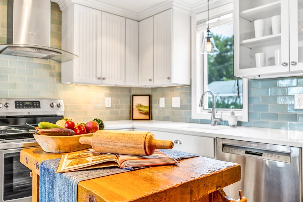 396 Plainfield Road, Unit 396 Concord, MA 01742 - Photo 11 of 24 a kitchen with stainless steel appliances granite countertop a sink stove and cabinets