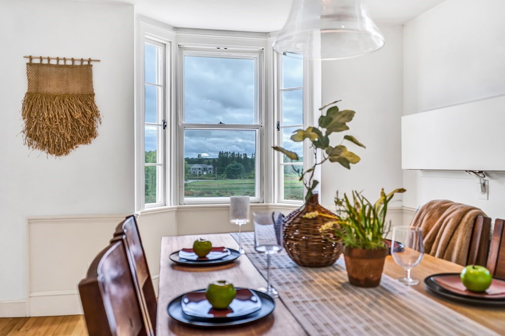396 Plainfield Road, Unit 396 Concord, MA 01742 - Photo 15 of 24 a dining room with furniture and wooden floor