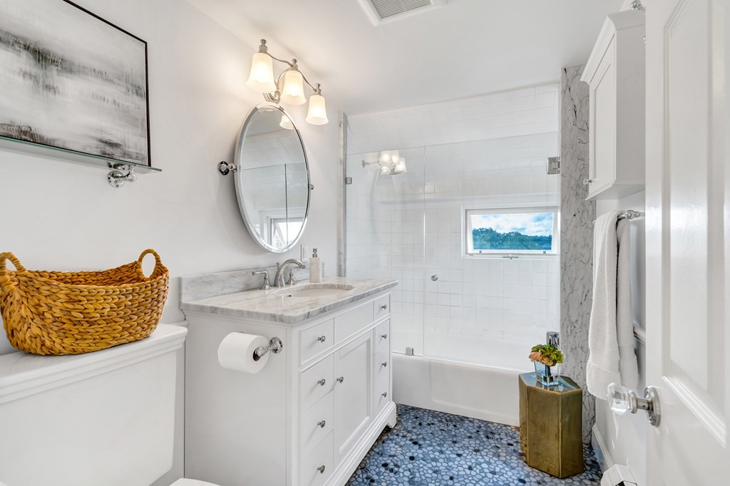 396 Plainfield Road, Unit 396 Concord, MA 01742 - Photo 18 of 24 a bathroom with a sink a mirror and a shower