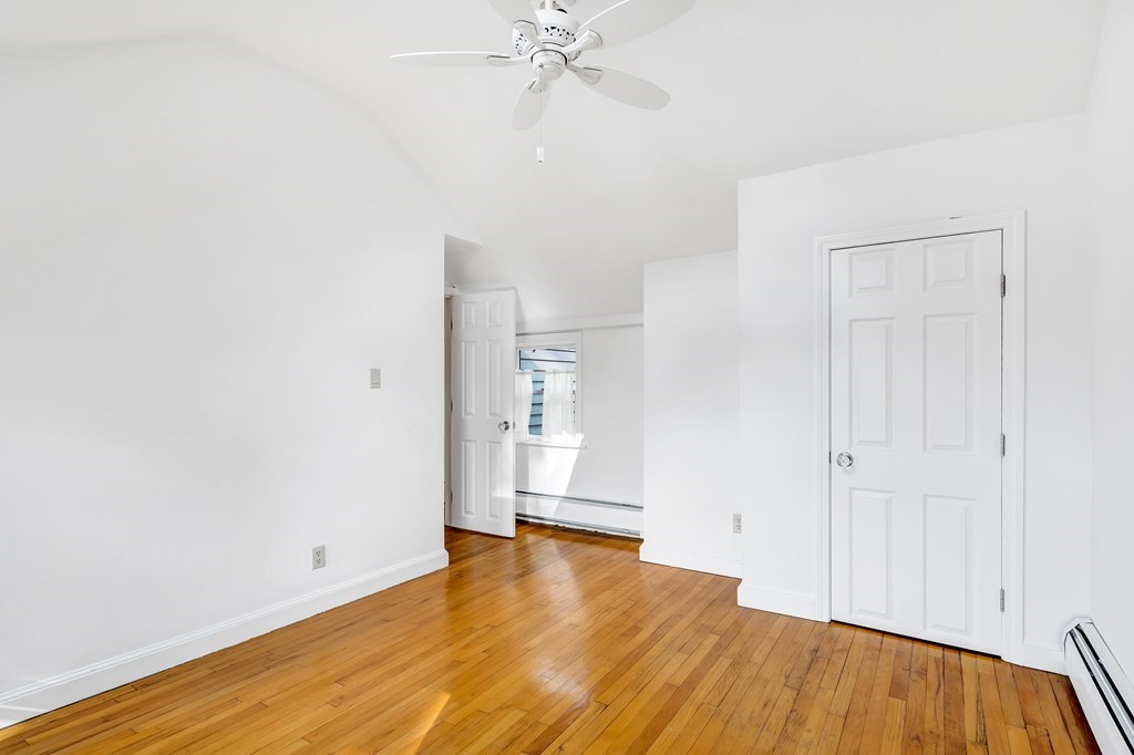 396 Plainfield Road, Unit 396 Concord, MA 01742 - Photo 19 of 24 a view of an empty room with wooden floor