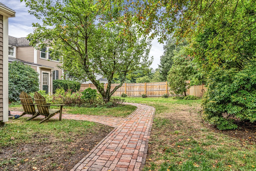 396 Plainfield Road, Unit 396 Concord, MA 01742 - Photo 23 of 24 a front view of a house with a yard and trees