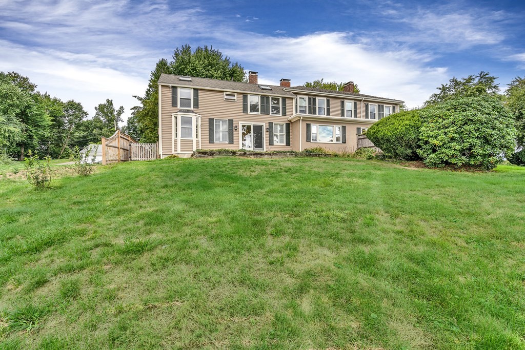 396 Plainfield Road, Unit 396 Concord, MA 01742 - Photo 24 of 24 a view of a house with a yard and plants