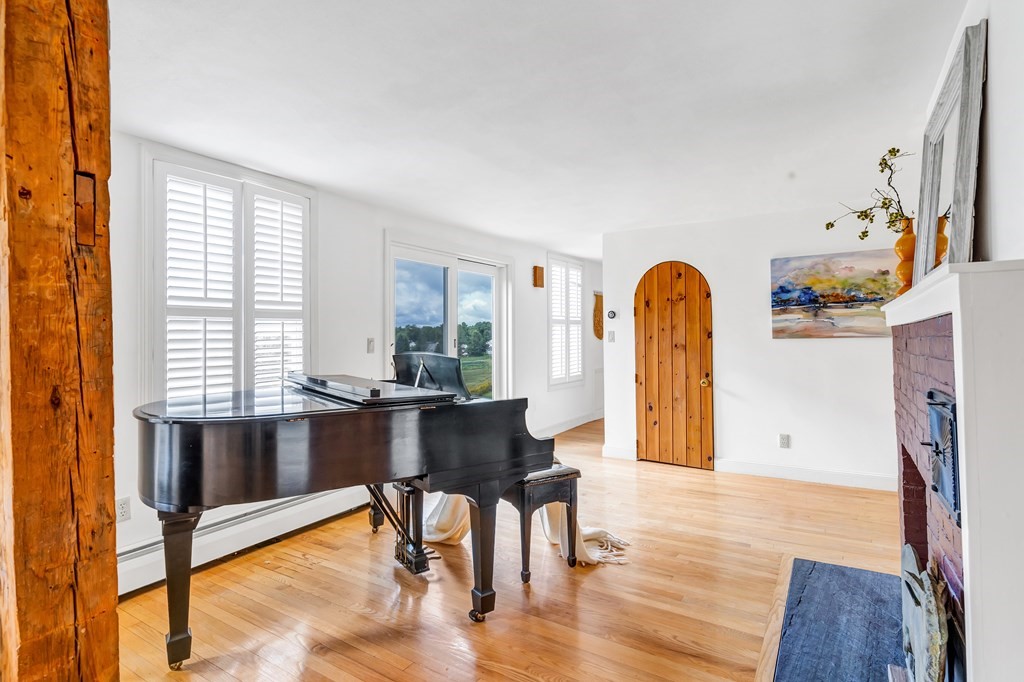 396 Plainfield Road, Unit 396 Concord, MA 01742 - Photo 6 of 24 a living room with furniture a large window and wooden floor