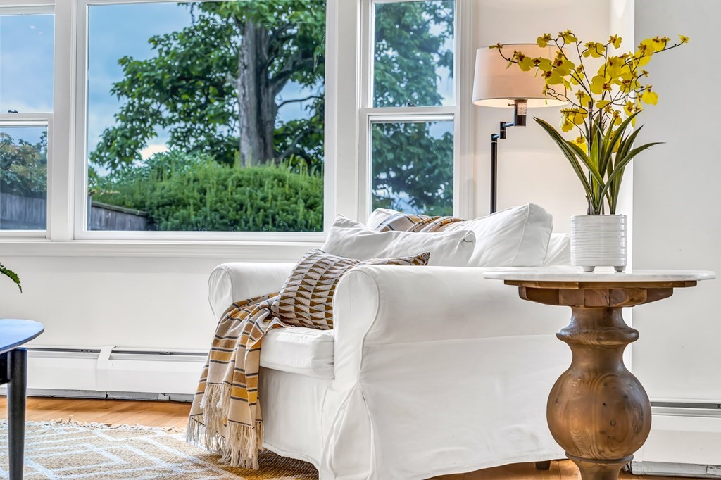 396 Plainfield Road, Unit 396 Concord, MA 01742 - Photo 7 of 24 a vase of flowers sitting on a table with wooden floor