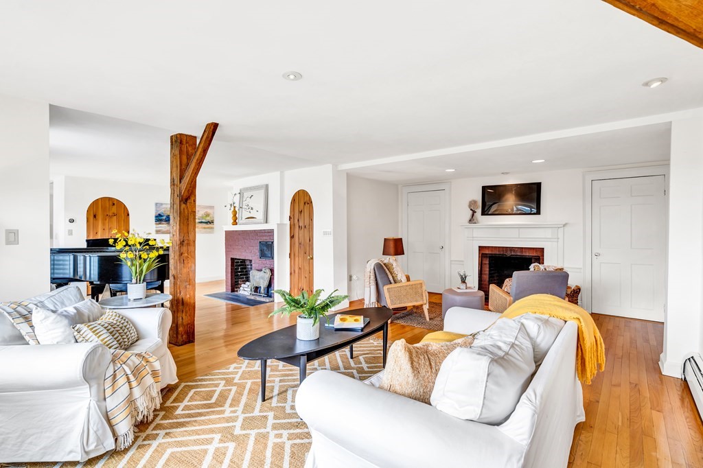 396 Plainfield Road, Unit 396 Concord, MA 01742 - Photo 8 of 24 a living room with furniture a fireplace and a flat screen tv