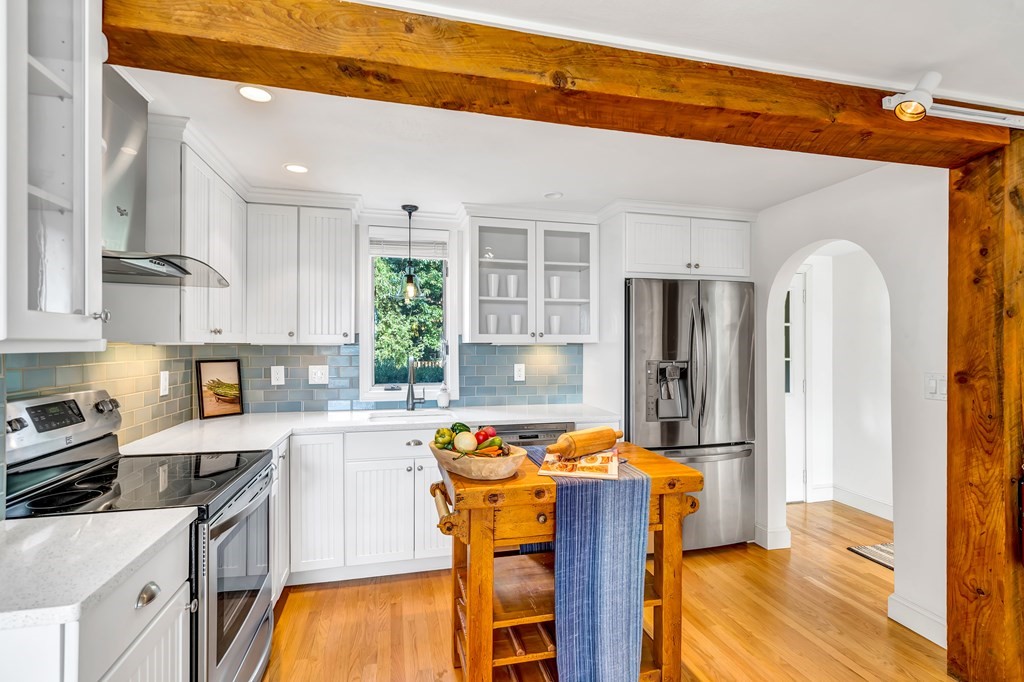 396 Plainfield Road, Unit 396 Concord, MA 01742 - Photo 10 of 24 a kitchen with stainless steel appliances granite countertop a stove refrigerator sink and cabinets
