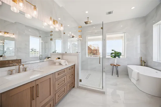 a spacious bathroom with a double vanity sink mirror and a bathtub