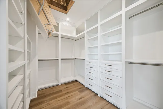 a view of walk in closet with empty racks