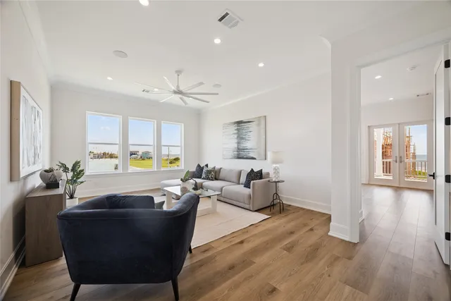 a living room with furniture and a wooden floor