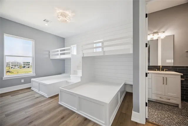 a spacious bedroom with a bed and a table