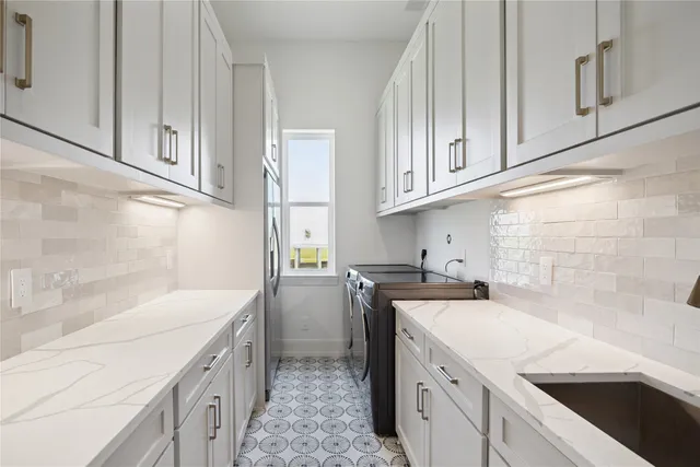 a kitchen with a sink stove and cabinets