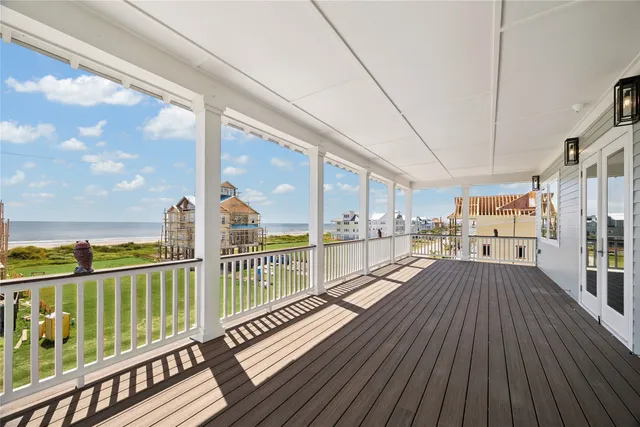 a view of a balcony with wooden floor