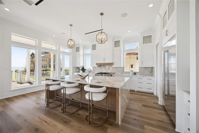 a large kitchen with a table and chairs