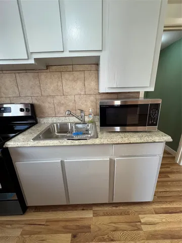 a stove top oven sitting inside of a kitchen