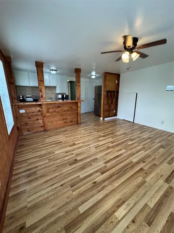 a view of a livingroom with a hall and furniture