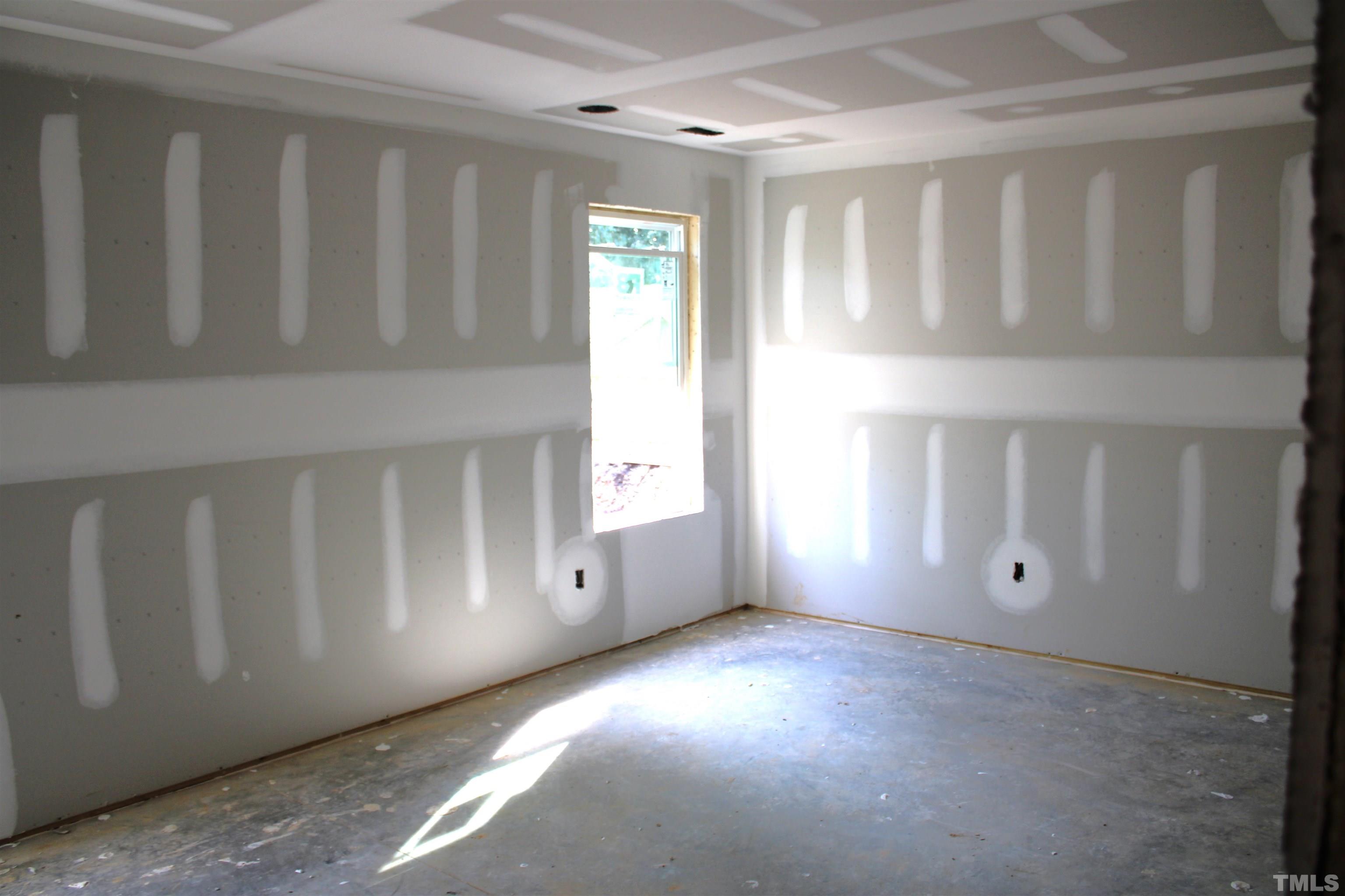 110 Alcott Street Sanford, NC 27330 - Photo 15 of 20 a view of an empty room with window and stairs