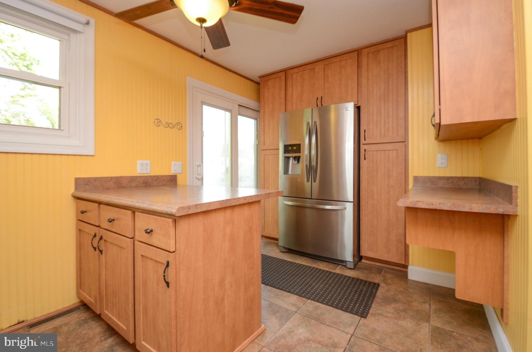 8107 Hillendale Road Baltimore, MD 21234 - Photo 22 of 30 a kitchen with stainless steel appliances a refrigerator and a chandelier