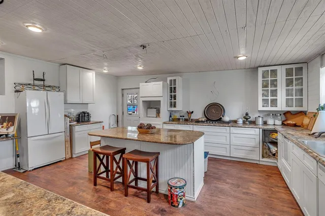 a kitchen with sink a stove and refrigerator