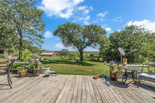 a view of a deck with chairs and a yard