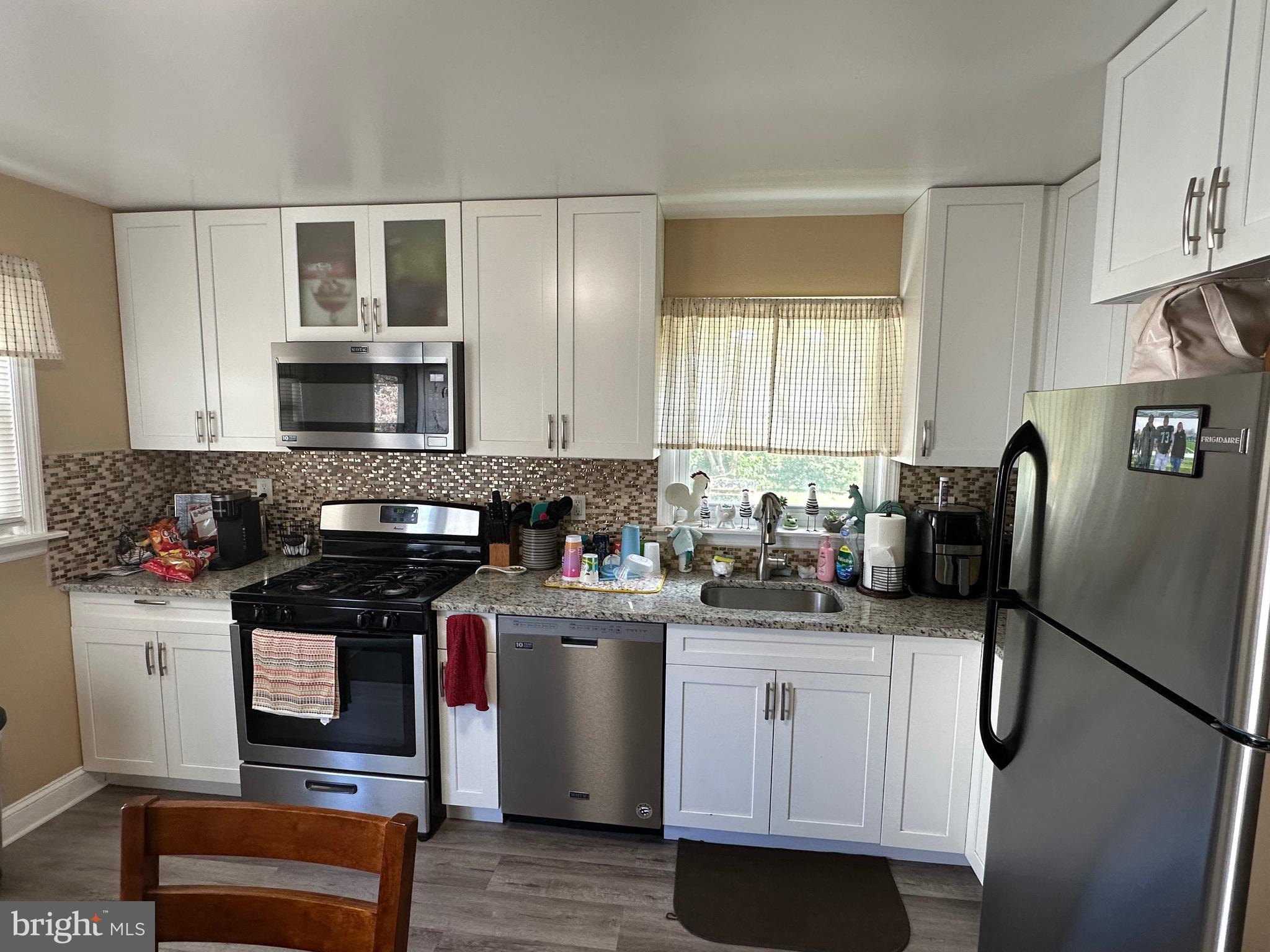 29 Petty Ridge Road Hamilton, NJ 08620 - Photo 16 of 47 a kitchen with stainless steel appliances a stove a sink and a refrigerator
