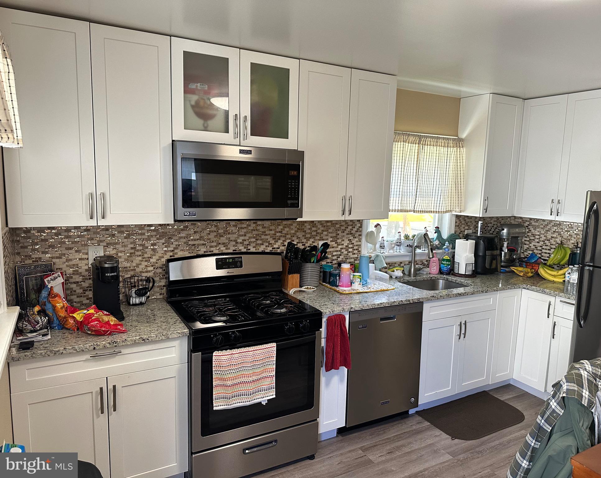 29 Petty Ridge Road Hamilton, NJ 08620 - Photo 18 of 47 a kitchen with granite countertop cabinets stainless steel appliances and a window