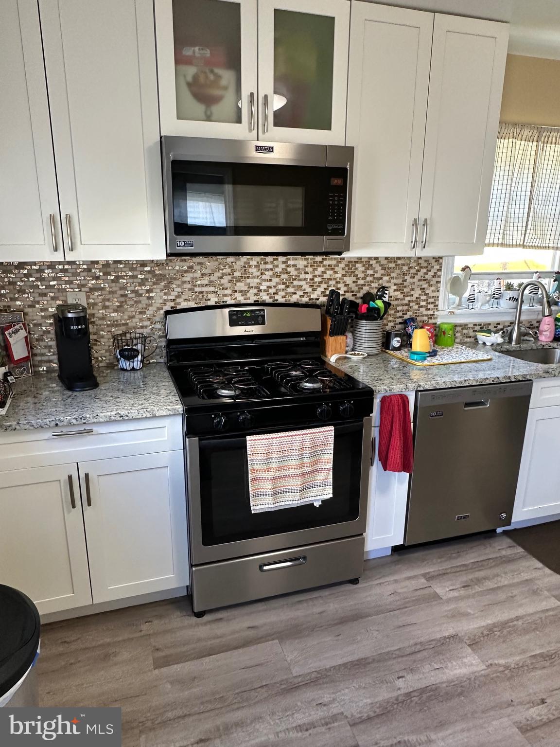 29 Petty Ridge Road Hamilton, NJ 08620 - Photo 20 of 47 a kitchen with stainless steel appliances kitchen island granite countertop a stove a sink and a microwave