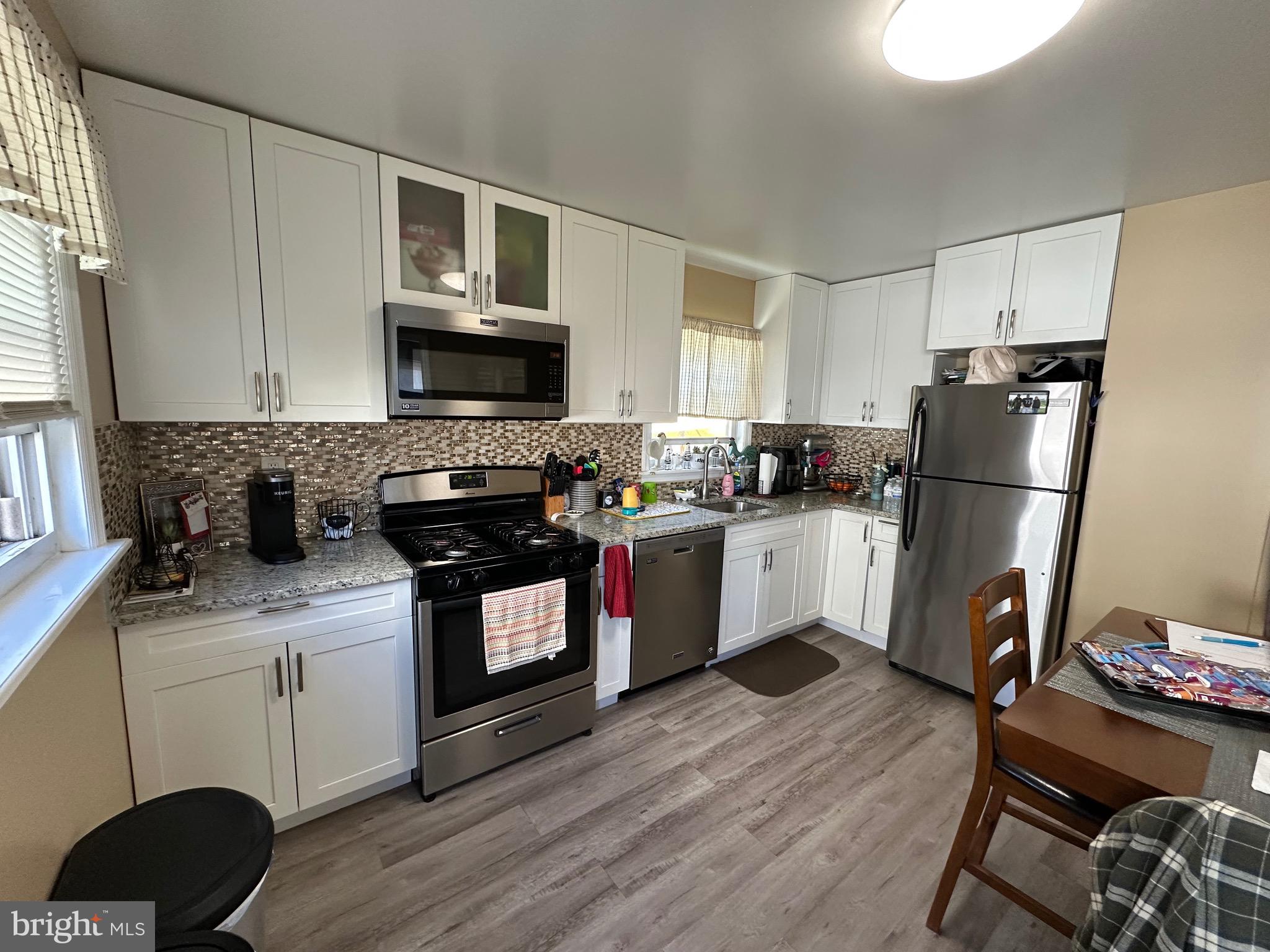 29 Petty Ridge Road Hamilton, NJ 08620 - Photo 22 of 47 a kitchen with a refrigerator a microwave a sink and cabinets