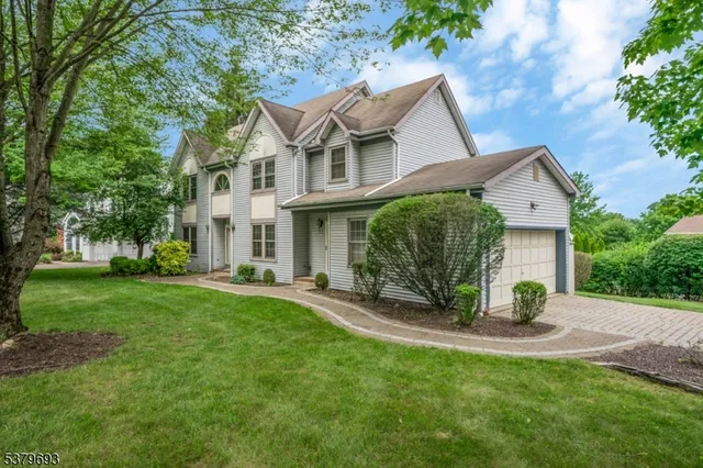 a view of an house with backyard and a garden