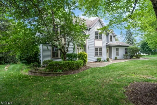 a front view of a house with a yard and porch